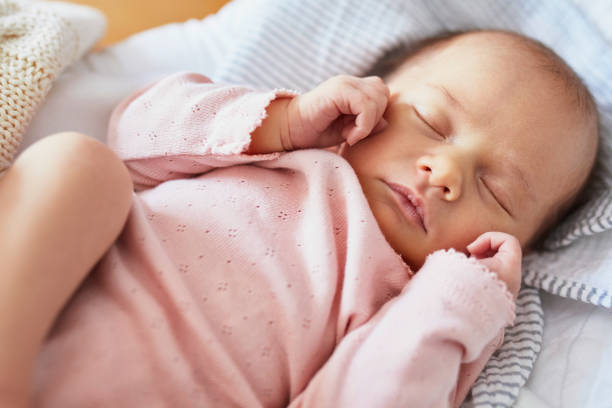 Newborn baby sleeping Newborn baby girl sleeping peacefully in the crib baby girls stock pictures, royalty-free photos & images