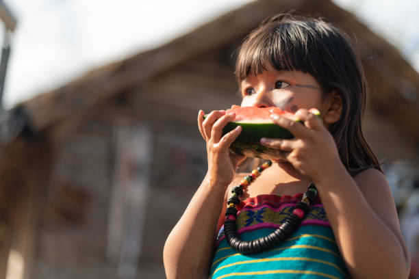 Child Eating Watermelon Beautiful shooting of how Brazilian Natives lives in Brazil indigenous culture stock pictures, royalty-free photos & images