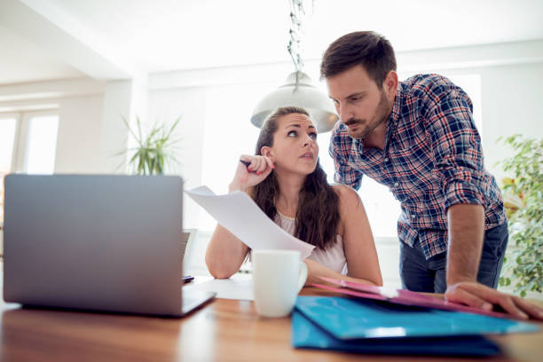 istock Worried young couple doing their accounts 1017725192