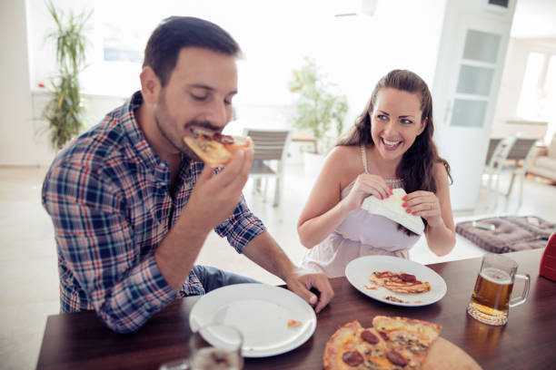 istock Happy couple eating pizza 1017725198