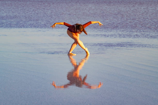 istock Ballerina dancing on the lake at sunset. 1017730092