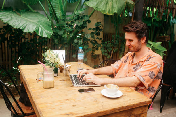 istock Young freelancer man doing online work in a cafe in Thailand 1017736006