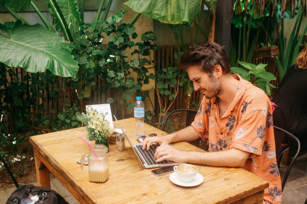 istock Young freelancer man doing online work in a cafe in Thailand 1017738614