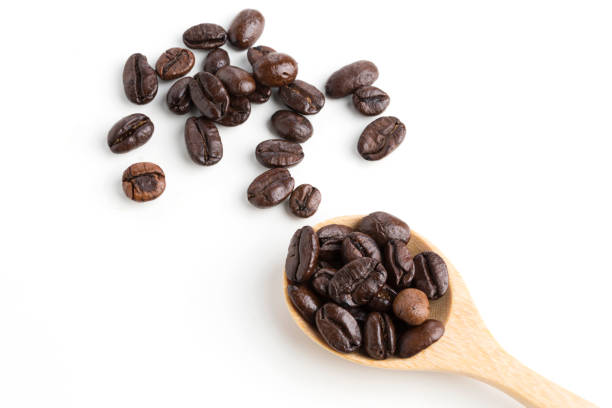 istock roasted coffee beans on wooden spoon isolated on white background. 1017741612