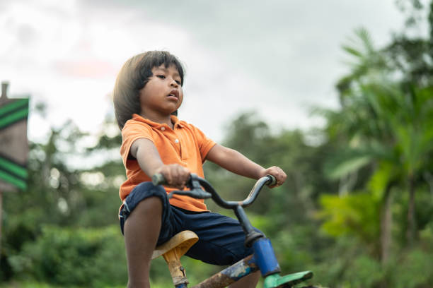 istock Child Riding a Bicycle in The Rural Place 1017741646