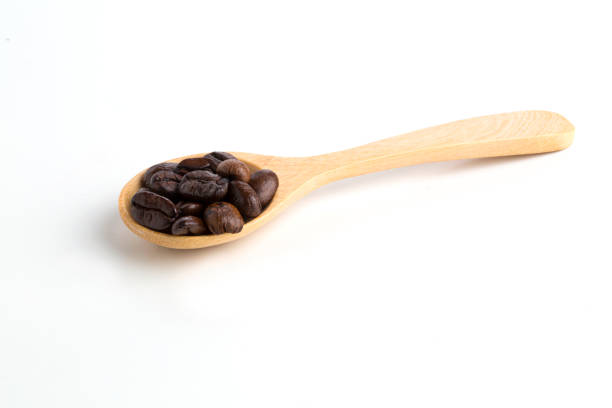 istock roasted coffee beans on wooden spoon isolated on white background. 1017741674