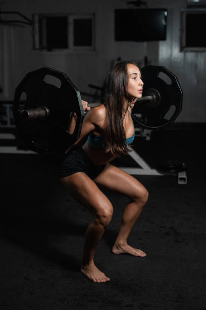 istock Female training with barbell, pumping legs 1017768826