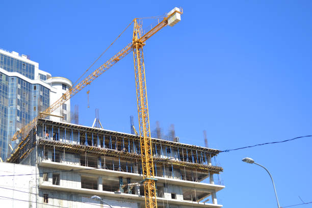 istock Construction of an apartment house with a crane. 1017778732