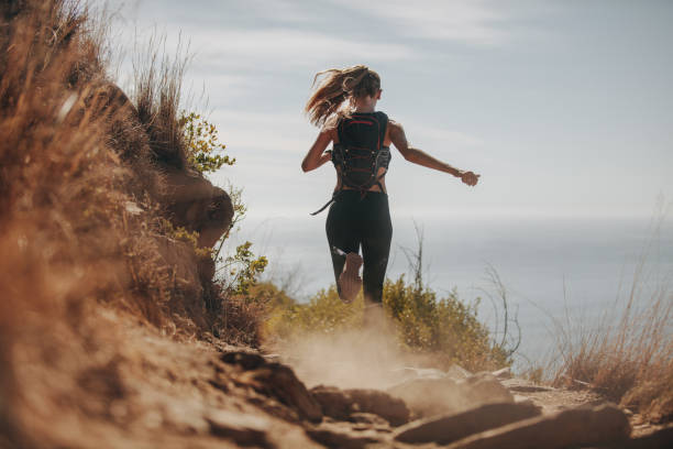 istock Female running over rocky trails on the hillside. 1017782560