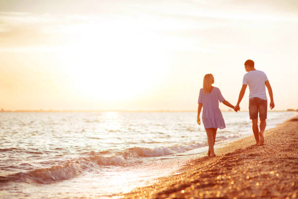 istock Young happy couple on seashore. 1017788122