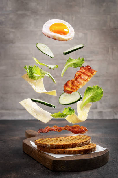 Breakfast sandwich in levitation above cutting board