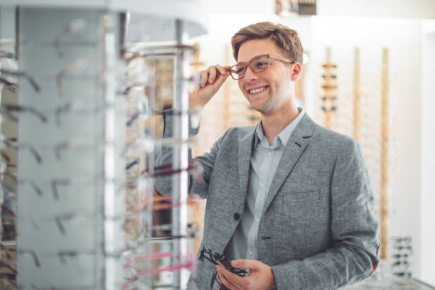 istock Young man buying sunglasses at the optical store 1017790444