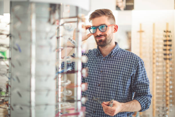 istock Young man buying sunglasses at the optical store 1017790662