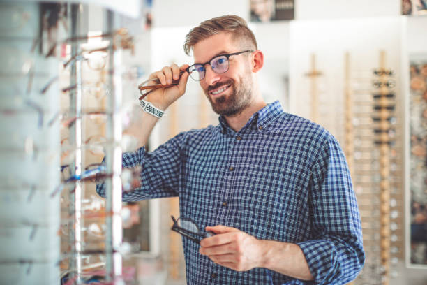 istock Young man buying sunglasses at the optical store 1017790674