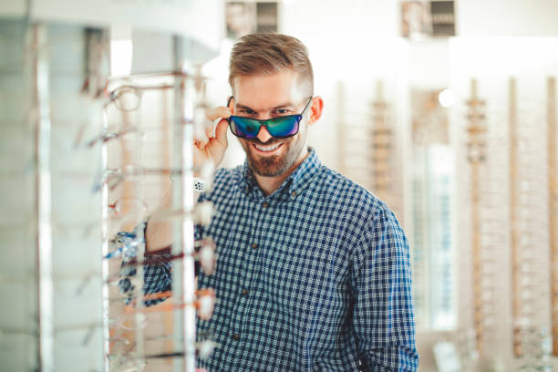 istock Young man buying sunglasses at the optical store 1017790732