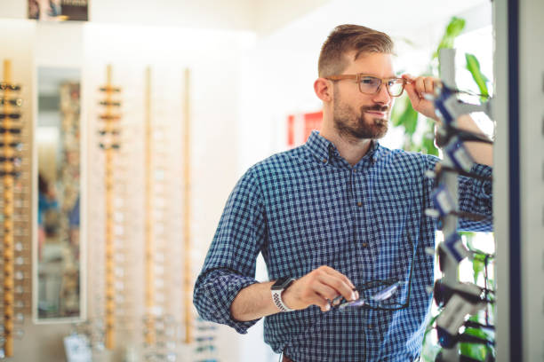 istock Young man buying sunglasses at the optical store 1017790814