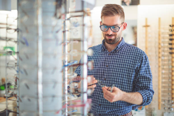 istock Young man buying sunglasses at the optical store 1017790972
