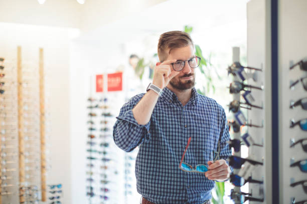 istock Young man buying sunglasses at the optical store 1017791034