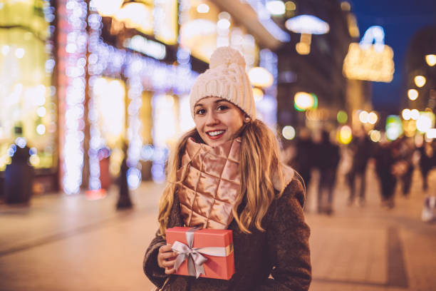 istock Young woman holds a Christmas present 1017791238