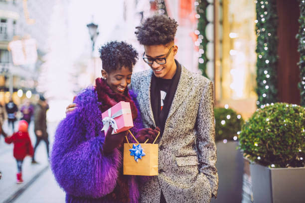 istock Young couple is opening a Christmas present 1017791276