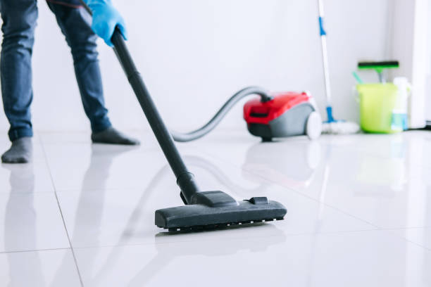istock Housekeeping and housework cleaning concept, Happy young man in blue rubber gloves using a vacuum cleaner on floor at home 1017791446