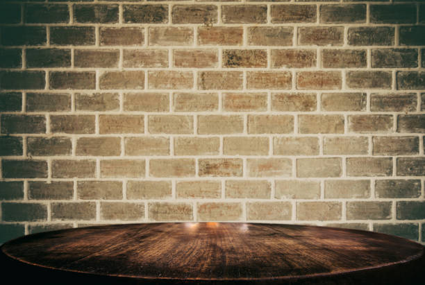 istock Selected focus empty black wooden table and wall texture or old black brick wall blur background image. for your photomontage or product display 1017793044