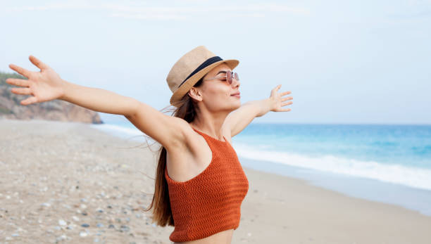 istock woman relaxing at the beachside 1017801246