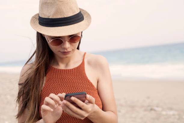 istock woman relaxing at the beachside 1017801252