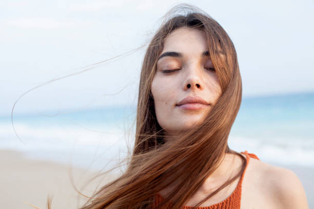 istock woman relaxing at the beachside 1017801422
