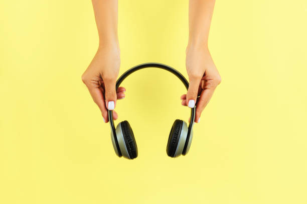 istock Female Hands Holding Headphones 1017809560