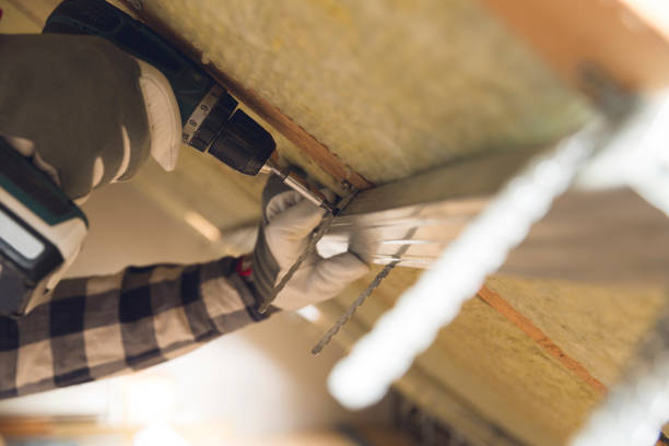 istock Man installing thermal roof insulation layer - using mineral wool panels. Attic renovation and insulation concept 1017810638