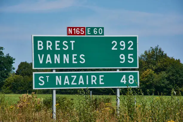 French green sign on the N165 E60 motorway near Nantes with distances to Brest and Vannes and Saint Nazaire