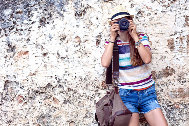 istock beautiful attractive woman taking photo by camera 1017826828