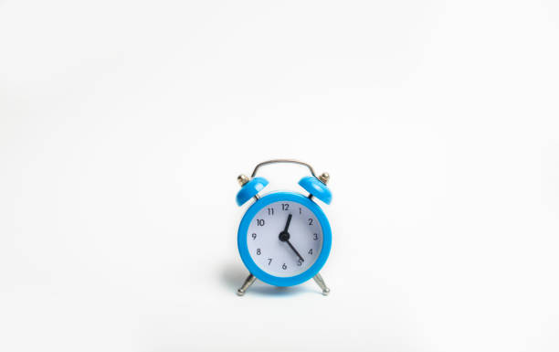 istock blue alarm clock on white background indicates the beginning of the first. time management. concept of the flow of time, time to action. minimalist style. Time is money. 1017829682