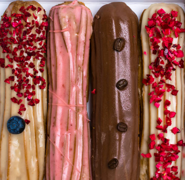 istock delicious colored eclairs with coffee beans and blueberry 1017841914