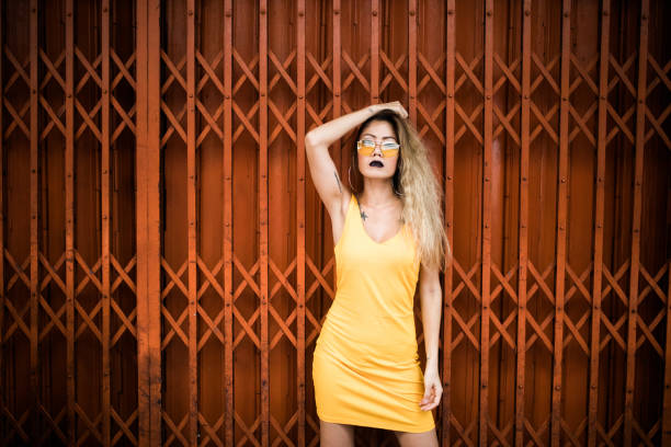 istock Woman leaning on orange gate 1017845544