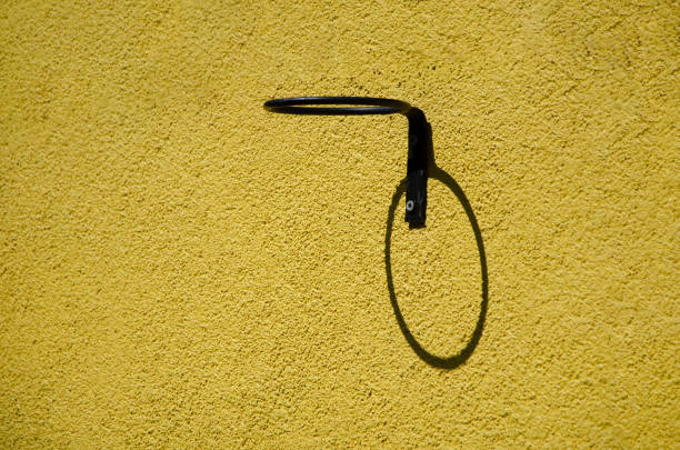 Black metal roller on yellow background. minimal concept idea.