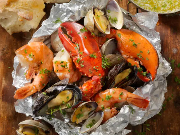 Tin Foil Wrapped Shellfish with Lobster, Tiger Prawns, Mussels, Clams and Vegetables