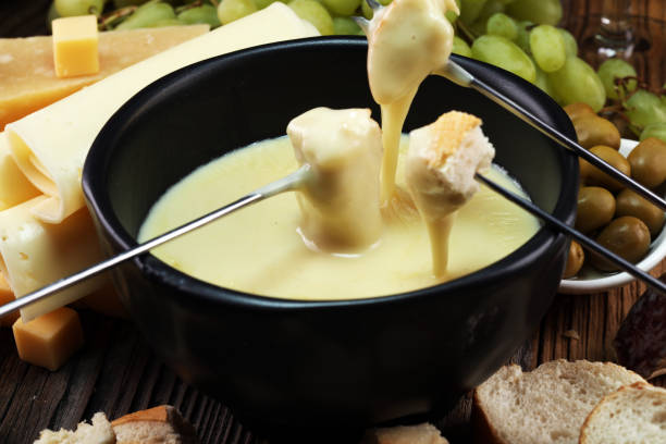 istock Gourmet Swiss fondue dinner on a winter evening with assorted cheese 1017855252