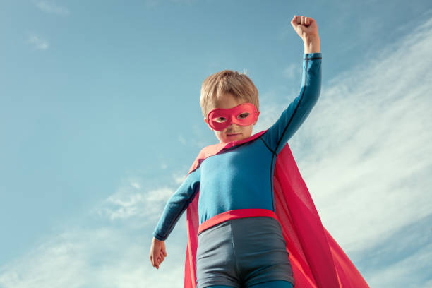 istock Superhero kid in red cape and mask 1017855270