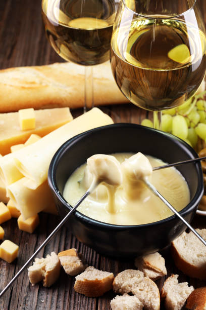 istock Gourmet Swiss fondue dinner on a winter evening with assorted cheese 1017855326