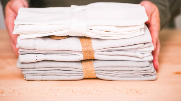 istock New linen dinner napkin on wood table. 1017857734
