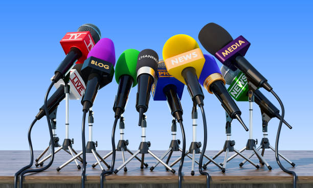 istock Microphones, press conference or interview concept on the wooden table. 3D rendering 1017858210