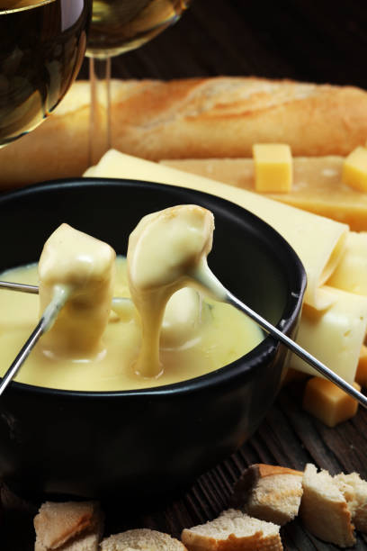 istock Gourmet Swiss fondue dinner on a winter evening with assorted cheese 1017865570