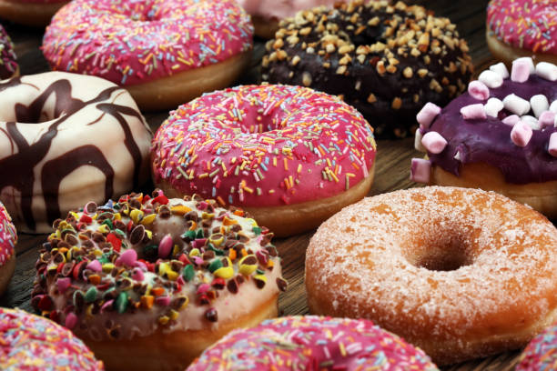 istock assorted donuts with chocolate frosted, pink glazed and sprinkles donuts 1017865796