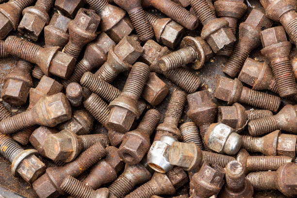 istock Used wheel bolts, texture background 1017866590