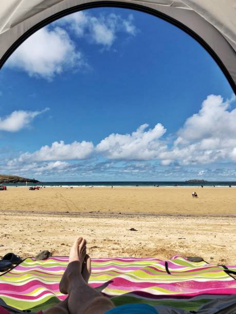 istock Sitting in a tent shading from the sun on a beach in Cornwall, England 1017872536