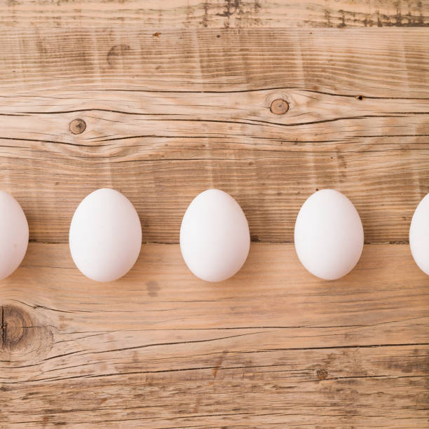 istock Top view on white eggs on a wooden background. Easter festive background. Flat lay. 1017872650