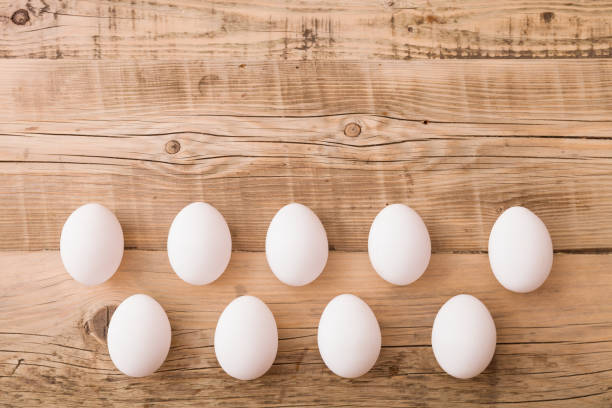istock Top view on white eggs on a wooden background. Easter festive background. Flat lay. 1017874692