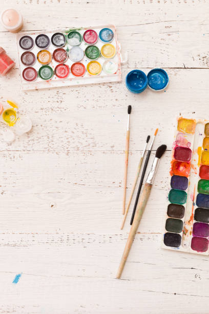 istock Top view on colorful paints and brushes. Creative ideas, creativity and early learning. Education concept. 1017876736